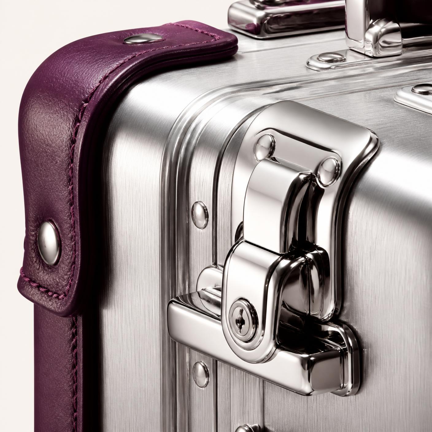 Macro detail of a polished latch and plum leather trim