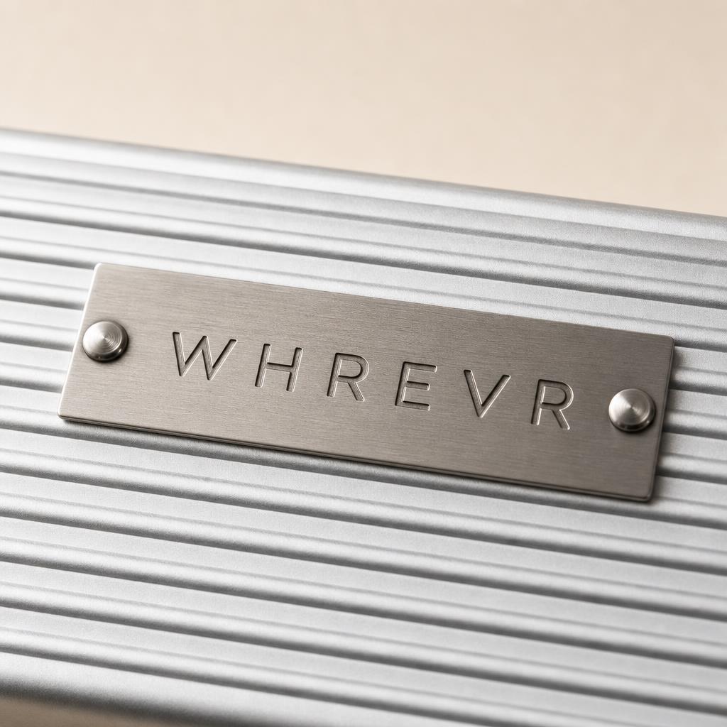 Serial plate detail on an aluminium suitcase